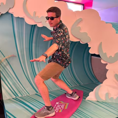 Image of Brian Perry standing in front of a wave prop